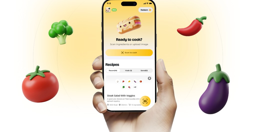 Hand holding a phone showing the Suphra scan-to-cook app, with 3D vegetables floating on a warm yellow background